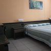 Camera da letto con pareti arancioni, letto matrimoniale e quadro floreale.