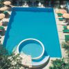Piscina rettangolare con piattaforma circolare e scivolo.