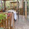 Veranda in legno apparecchiata per pranzo all'aperto.