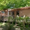 Casa mobile in legno con veranda e giardino.