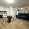 Cucina moderna con tavolo di vetro e divano.
