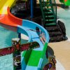 Scivolo colorato in un parco acquatico con bambino.
